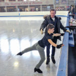 Michael Bramante working with skater on the ice.
